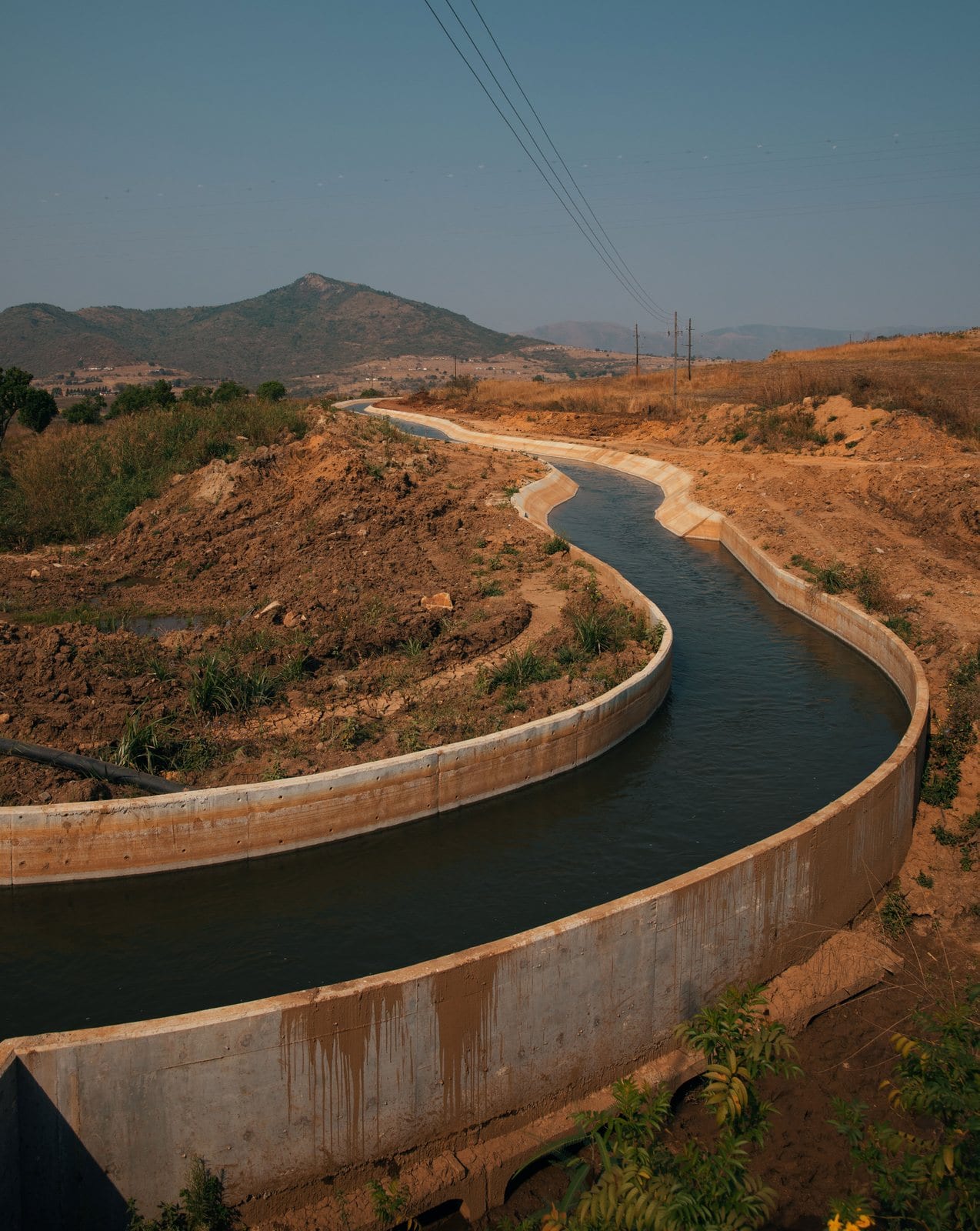 A water canal winding through the Eswatini landscape